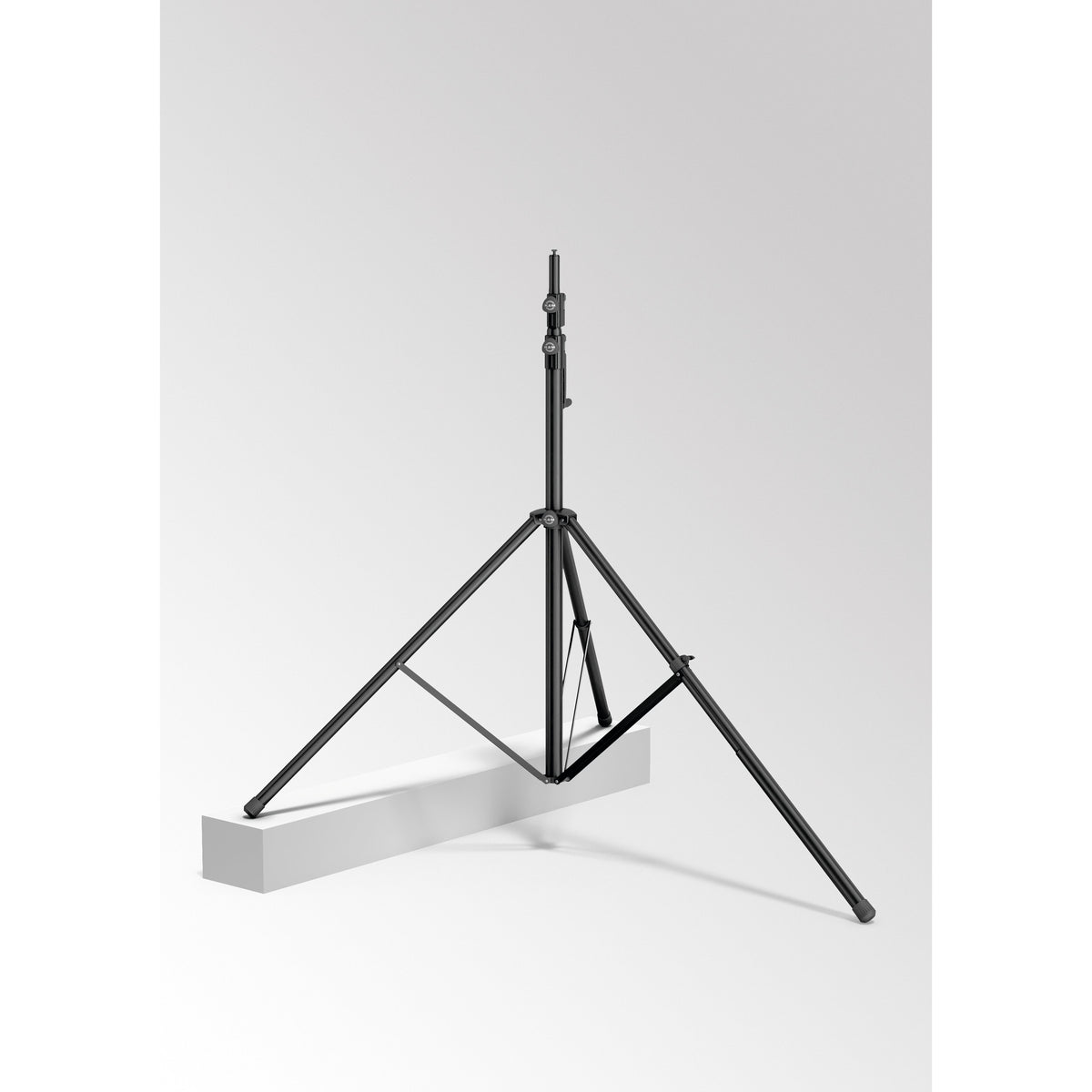24748 leveling leg in use on a wind-up speaker stand 4000 with one leg extended and resting on a raised white block to level the tripod base, K&M