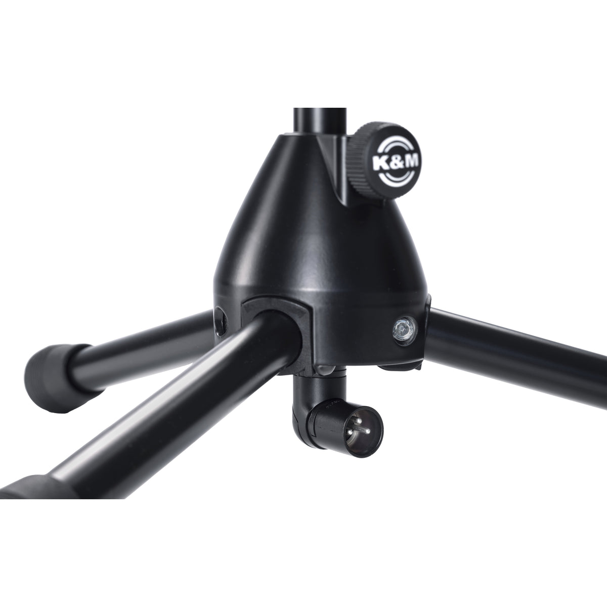 27500 tripod base close-up showing K&M logo locking knob, rubber-capped legs and male XLR output connector, K&M