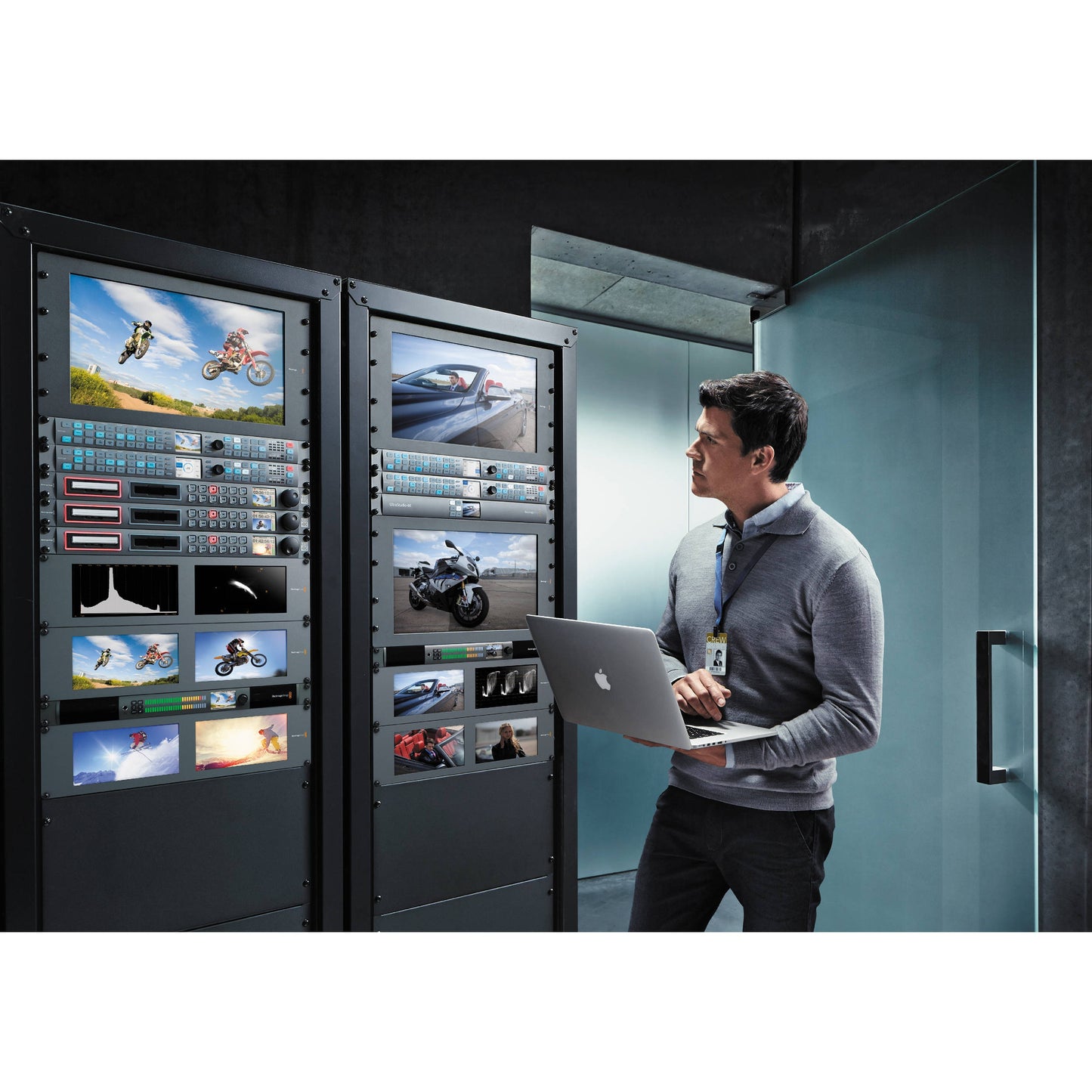Blackmagic Design Teranex Express converter rack mounted in a machine room with monitors and an engineer on a laptop