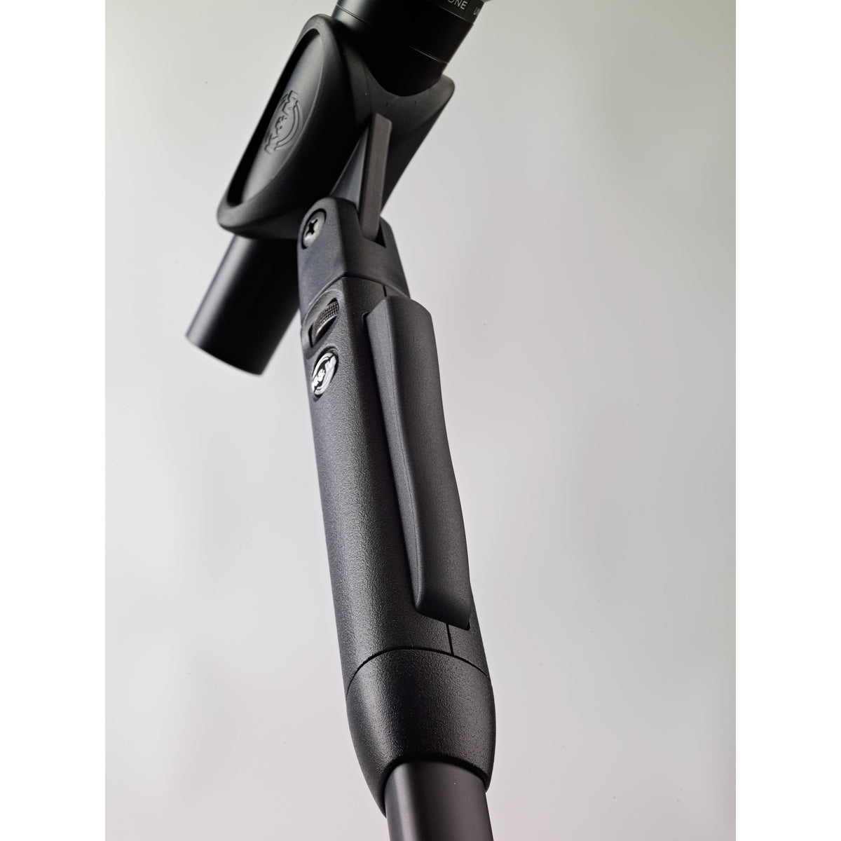 26200 Elegance One-Hand mic stand angled low view of textured grip housing and release lever below the microphone clip, K&M