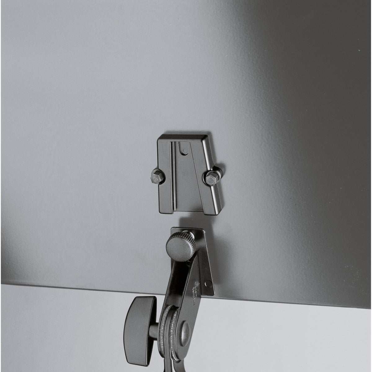 12155 laptop stand close-up of tray mounting plate with two bolts above the tilt joint clamp and knurled knob, K&M