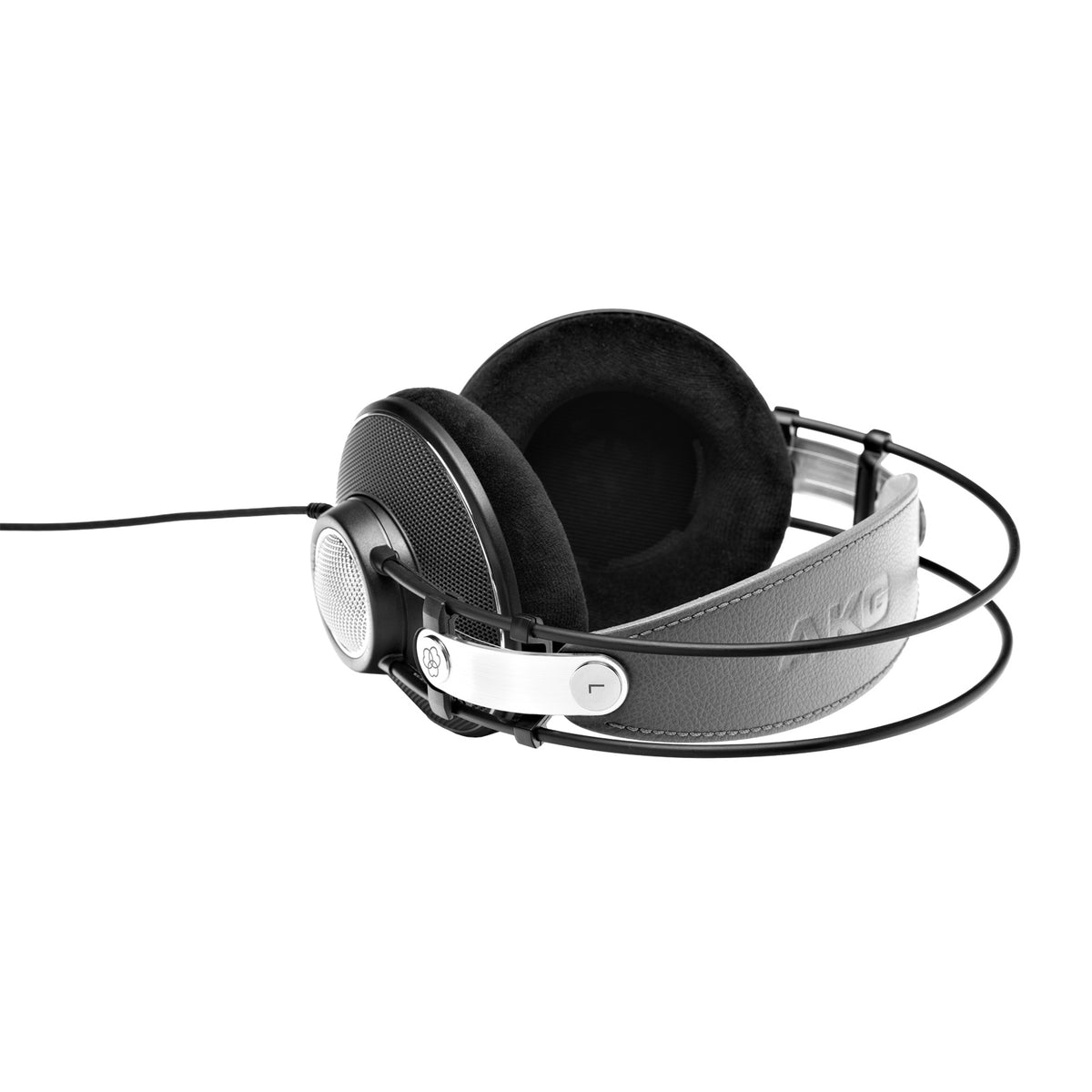 K612 Pro angled three-quarter view showing grey leather headband, brushed metal L slider and attached cable, AKG