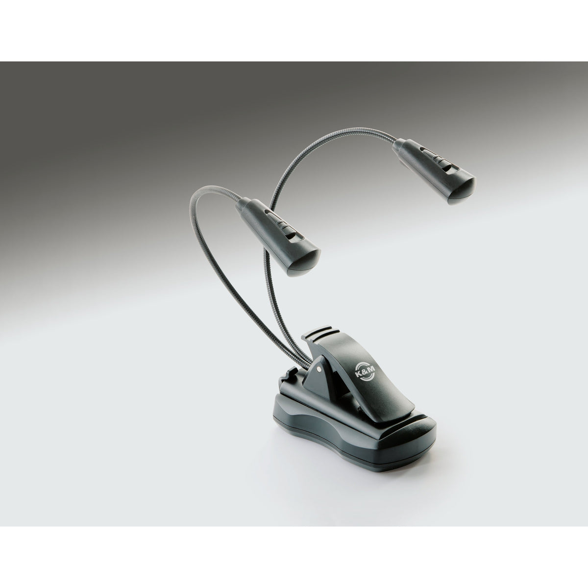 12256 FlexLight freestanding magnetic base in use holding a dual gooseneck LED clip light with K&M logo on the clamp, K&M