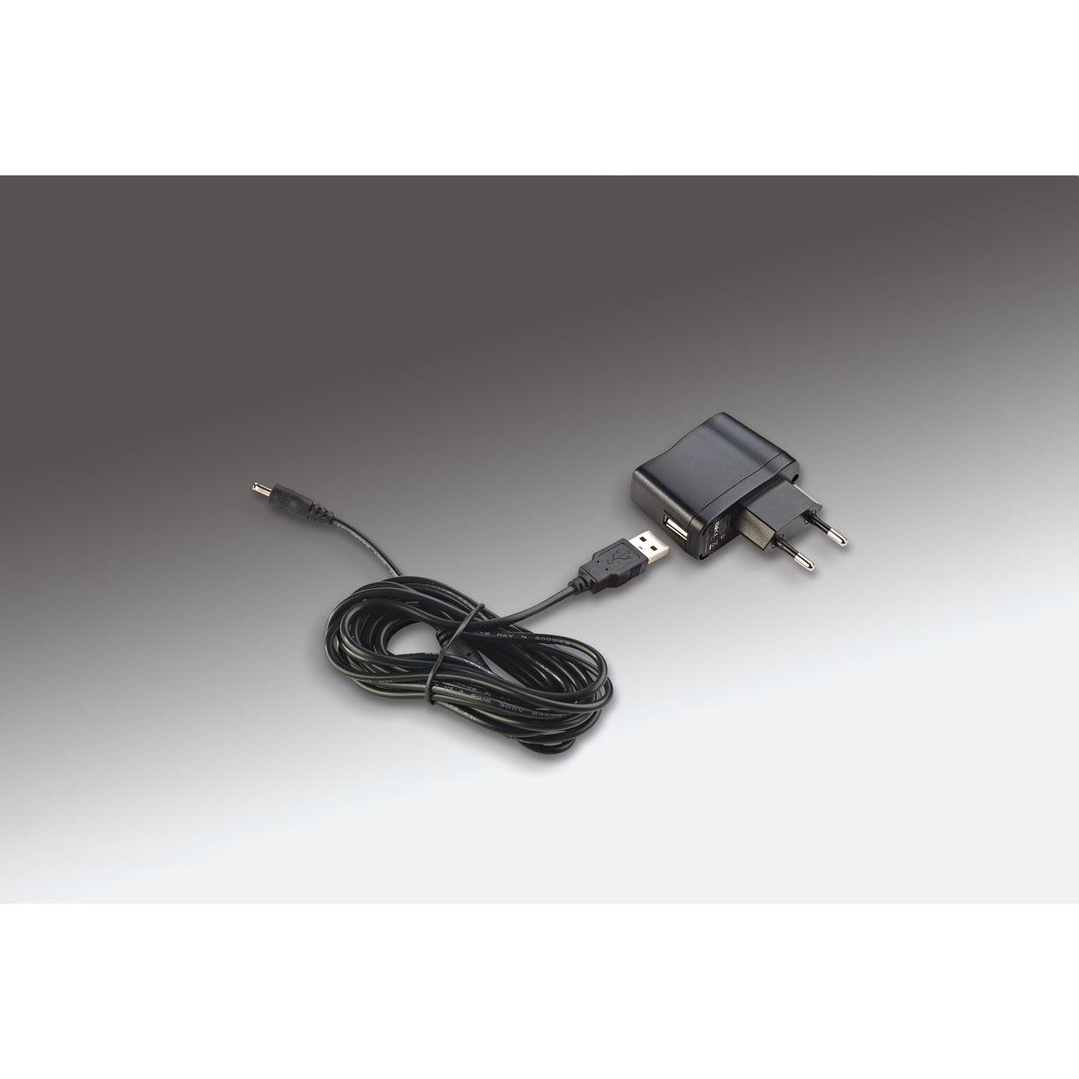 12298 LED piano lamp power supply accessories showing USB plug-in adapter with EU plug and coiled USB-to-DC barrel connector cable, K&M