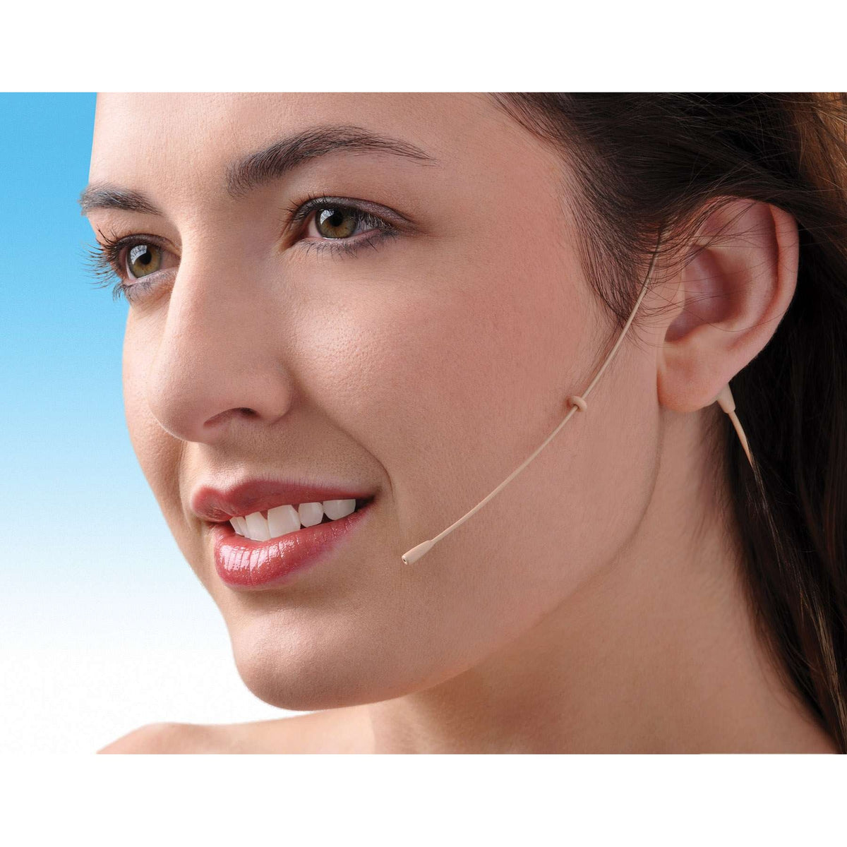 HM1725P omni earset mic in use, worn on a model with the beige boom positioned beside the mouth and ear hook behind the ear, Lectrosonics