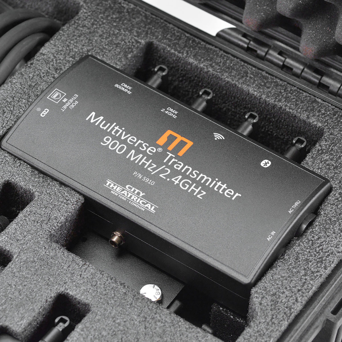 Multiverse Transmitter P/N 5910 900MHz/2.4GHz detail seated in kit foam showing DMX, Ethernet POE in and AC in/thru labeling, City Theatrical