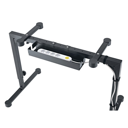 18808 cable organizer box mounted under Omega stand crossbar holding a white four-outlet power strip, viewed from below, K&M