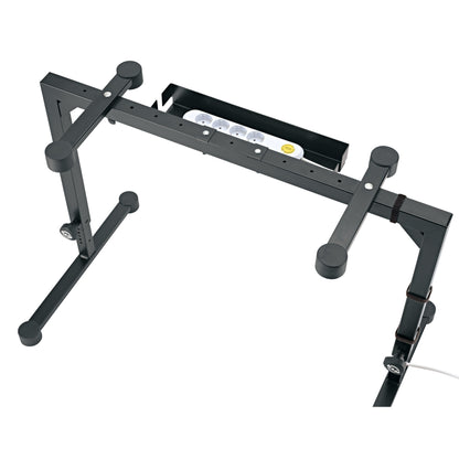 18808 cable organizer box attached to Omega stand crossbar with power strip seated inside and cable routed down the leg, K&M