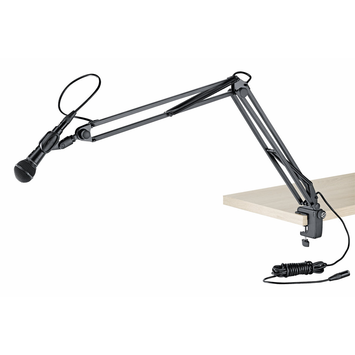 23850 desk microphone arm clamped to a wooden tabletop holding a handheld dynamic microphone with XLR cable routed along the boom, K&M