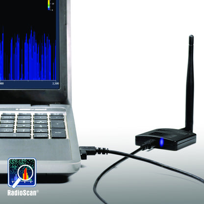RadioScan 5988 spectrum analyzer in use connected by USB to laptop running 2.4 GHz SSID scan, blue status LED lit, City Theatrical