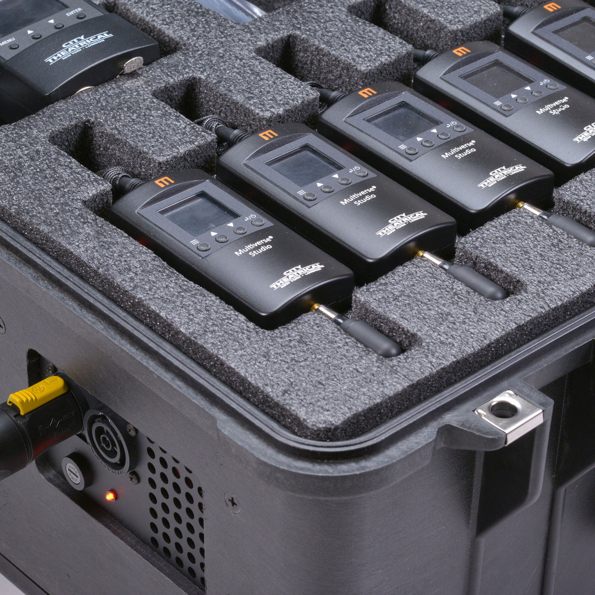 Multiverse Studio Add-On Kit 5941 close-up side view of transmitters in foam above the case-mounted powerCON inlet, vent and status LED, City Theatrical