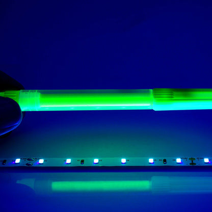 QolorFLEX UV LED tape detail with green highlighter fluorescing, DC24V and diode markings visible on strip, City Theatrical