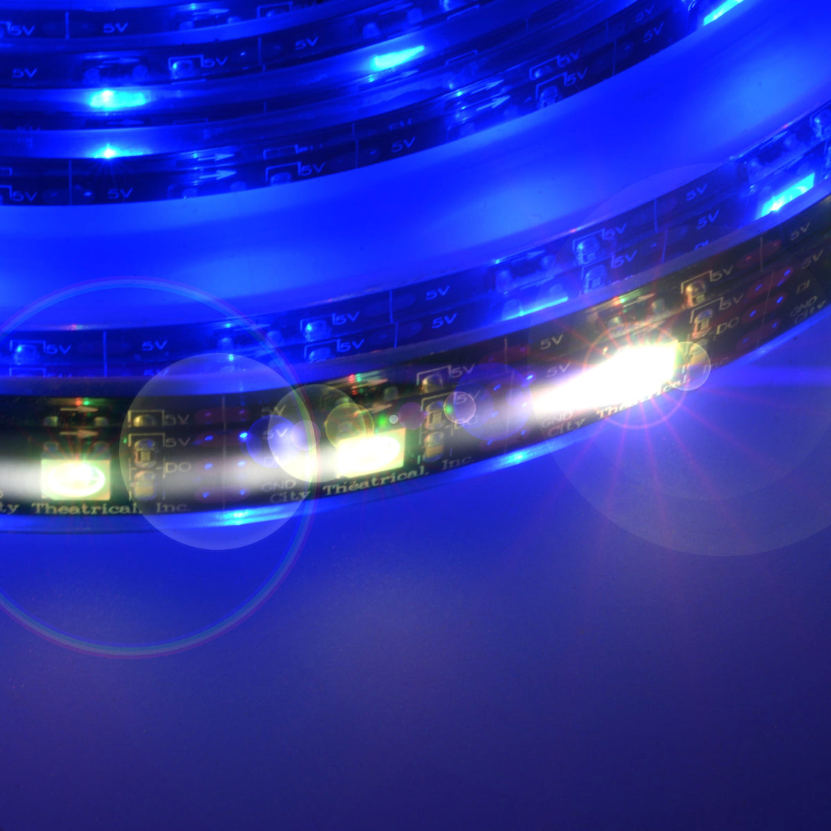 QolorPIX RGB LED tape close-up detail showing 5V pads and individually addressable pixels lit blue, City Theatrical