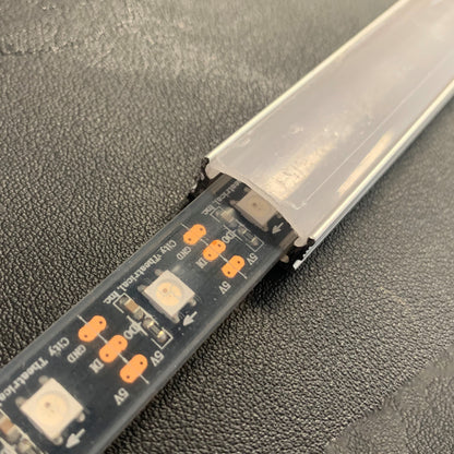 QolorPIX LED tape in extrusion channel close-up with frosted diffuser partially fitted over RGB pixels, City Theatrical