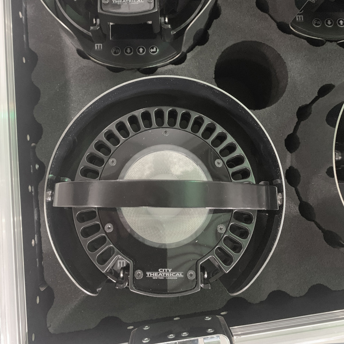 QolorPoint Mark 3 fixture detail in foam-lined road case showing finned heat sink, lens and yoke, City Theatrical