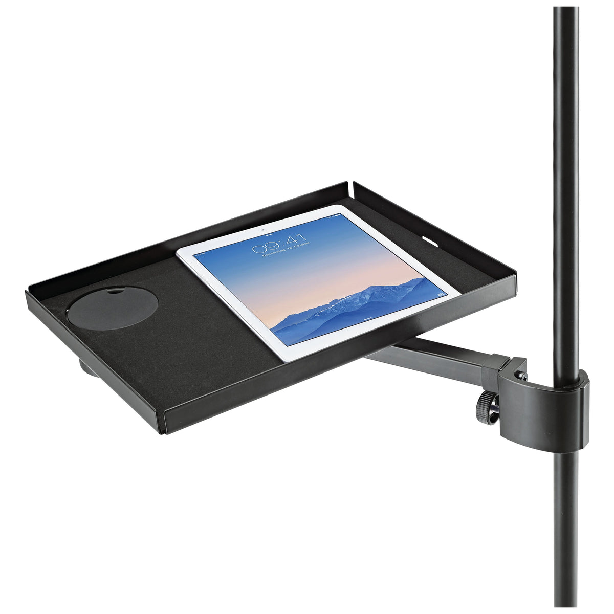 12225 steel utility tray in use on a mic stand, carrying a tablet with the cup holder cover fitted and cable slot visible in the rim, K&M
