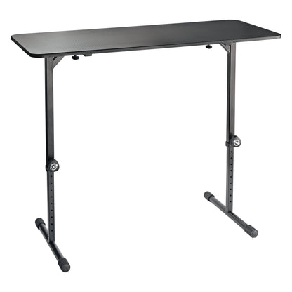 12160 portable DJ desk front three-quarter view with black tabletop and T-shaped steel legs with perforated height-adjustment holes and clamping knobs, K&M