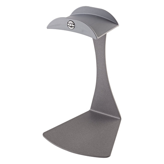 16075 headphone table stand front three-quarter view showing curved cradle with K&M logo and wide angled steel base in gray, K&M