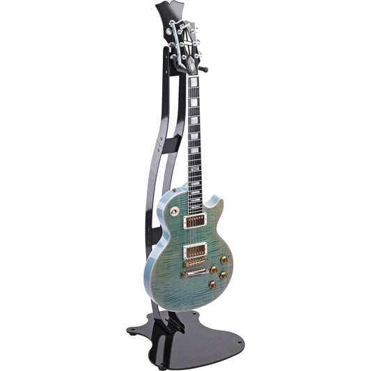 Guitar Station slim metal stand in use, holding a teal flame-top Gibson Les Paul style electric guitar upright on the gloss black frame, K&M