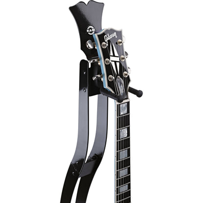 Guitar Station slim metal stand headstock detail, headstock-shaped top plate with K&M logo and padded rubber neck cradle supporting a Gibson headstock, K&M
