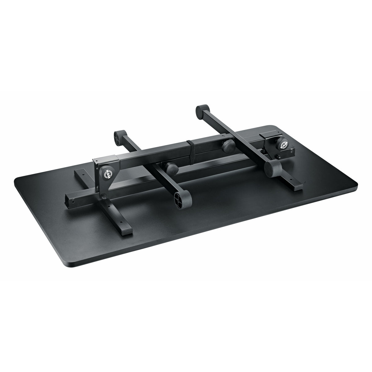 12170 folding DJ event table folded flat with legs collapsed against the underside of the black tabletop, showing hinge brackets and K&M logo, K&M