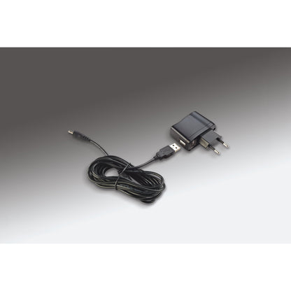 12298 LED piano lamp power supply detail showing USB mains adapter with coiled DC cable and barrel connector, K&M