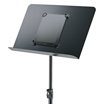 19708 magnetic tablet holder set mounted on a black music stand desk, tablet held at all four corners above the stand clamp, K&M