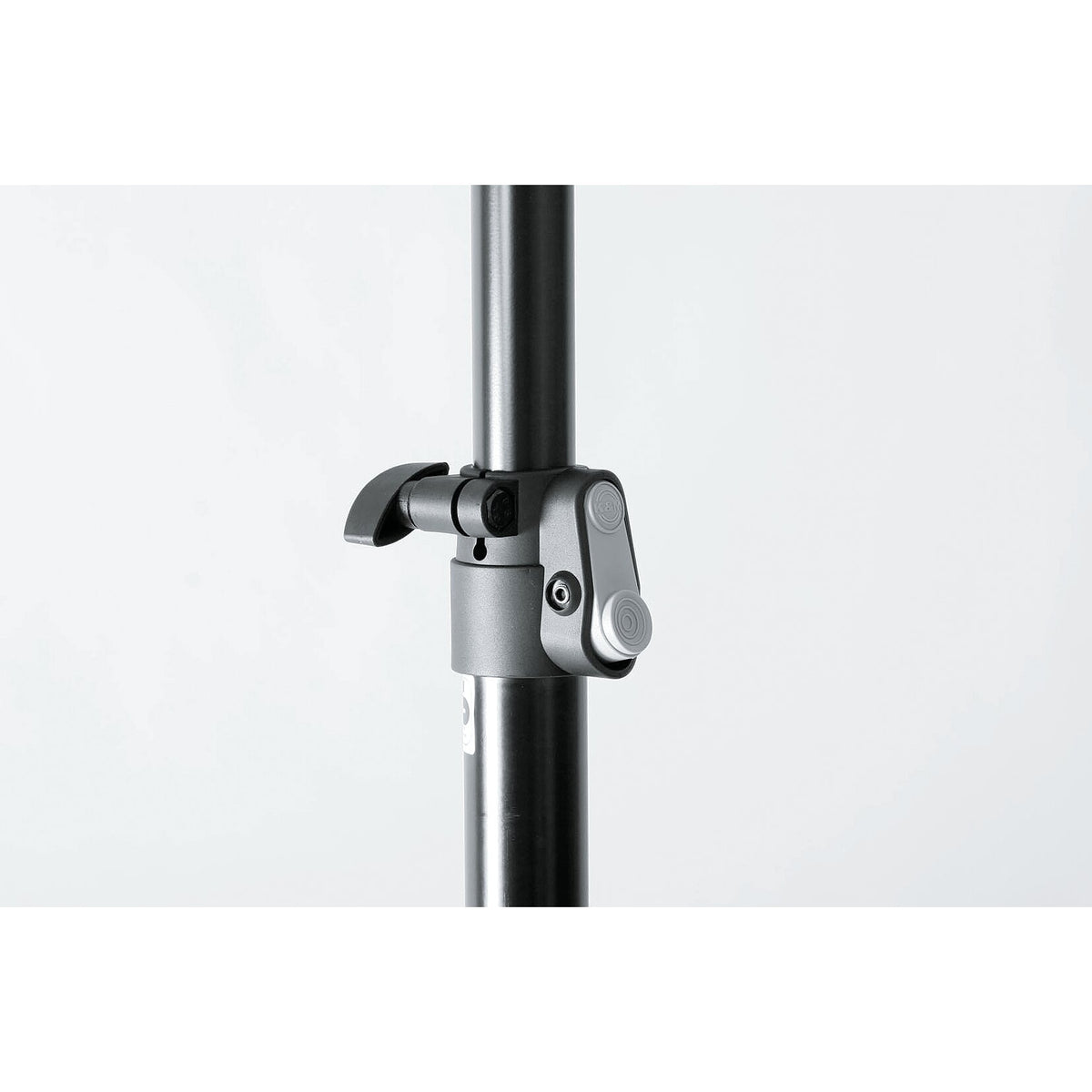 21454 speaker stand close-up of the grey height-adjustment clamp with quick-release lever and safety bolt on the black aluminum tube, K&M