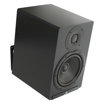 24167 wall mount holding a black studio monitor speaker, shown from the front right with the wall bracket visible behind the cabinet, K&M