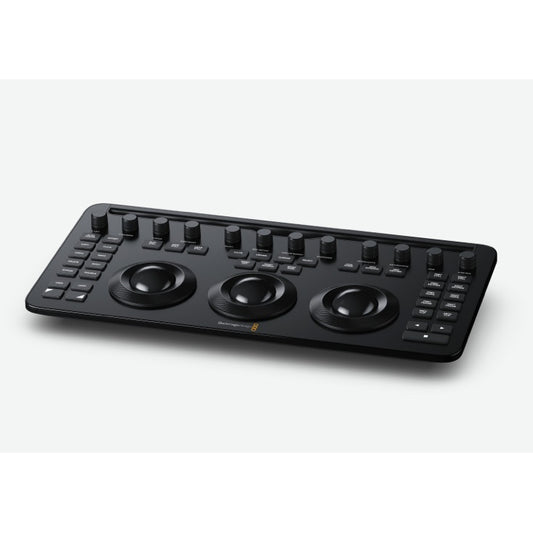 Blackmagic Design DaVinci Resolve Micro color grading panel at an angle showing three trackballs and knob row
