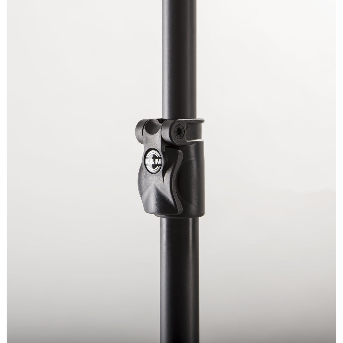 23765 mic boom pole close-up of telescoping section clamp with K&M logo and hex screw on black pole, K&M