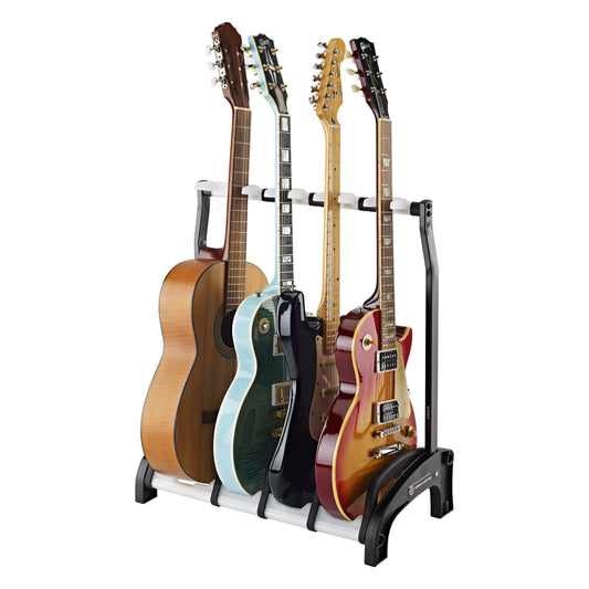17534 Guardian 3+1 four-guitar stand in use, holding an acoustic and three electric guitars upright against the padded neck rest bar, K&M