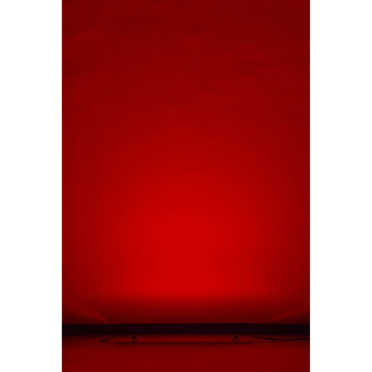 VDO Sceptron XB uplighting a wall in saturated red from floor position, Martin Lighting