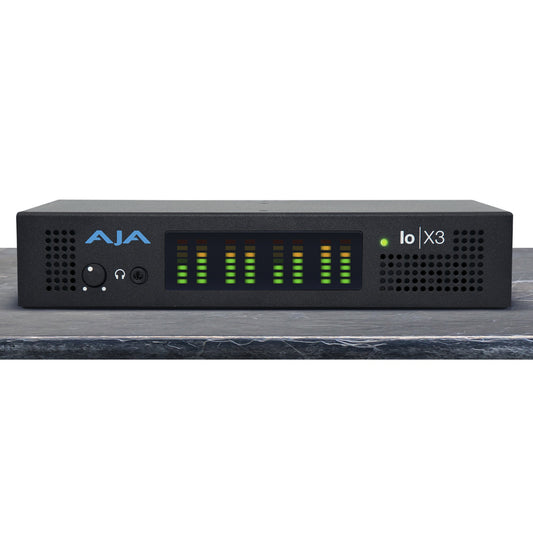 AJA Io X3 Thunderbolt 3 video I/O device front panel with audio level meters, headphone jack, and volume knob