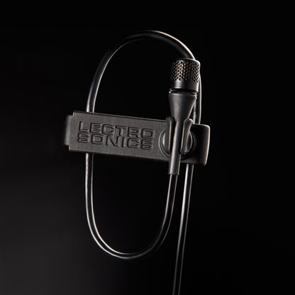 L1 Sonaura lavalier macro detail of perforated capsule grille and branded mic clip with cable loop, Lectrosonics