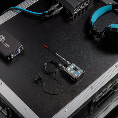 L1 Sonaura lavalier and DSSM transmitter staged on a flight case with DCR822 receiver and headphones, Lectrosonics