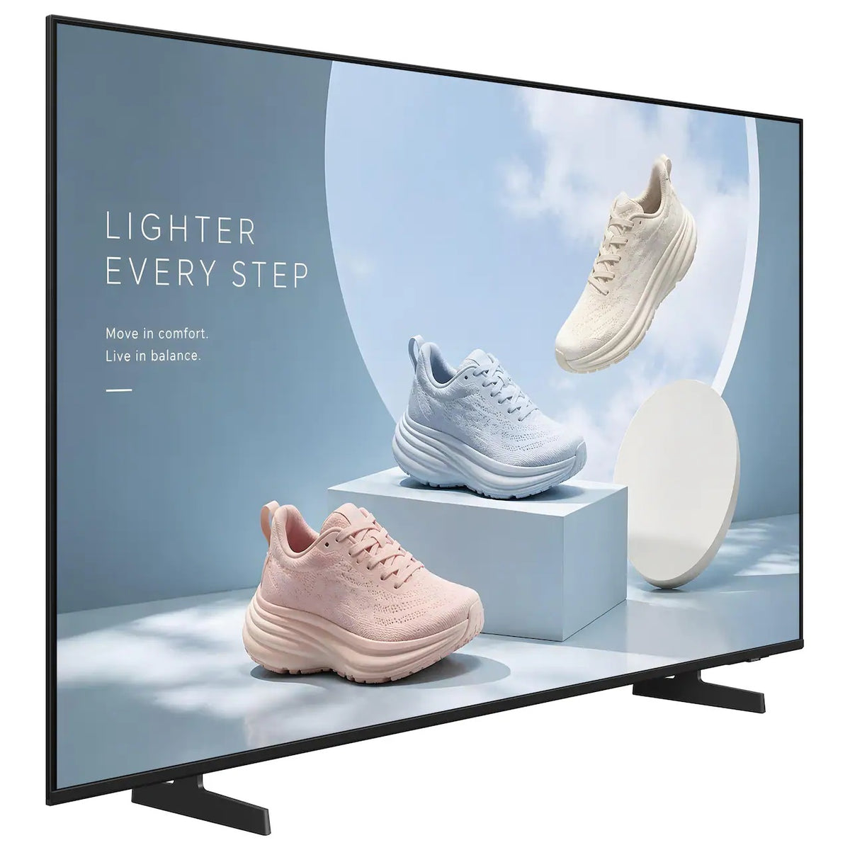 BE75HX-H 75" business display angled right three-quarter view showing slim bezel and tabletop feet with sneaker signage content, Samsung