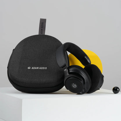 H715 reference headphones displayed beside black fabric carry case with Adam Audio logo and hanging loop, Adam Audio