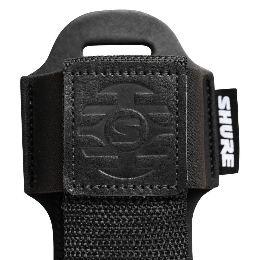 SH-BODYPACK-PBK-L bodypack transmitter pouch close-up of stitched embossed leather logo patch, woven nylon strap and Shure label, Gator