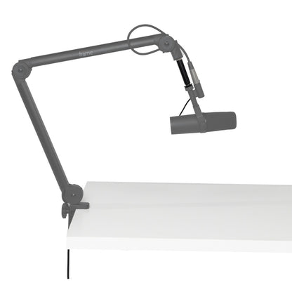 GFWMICBCBMEXT extension adapter fitted on desk-clamped broadcast boom arm holding a microphone, adapter highlighted in black, Gator