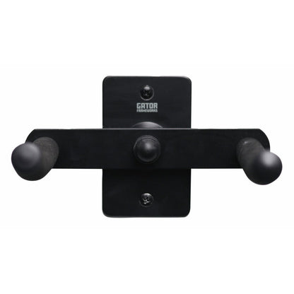 GFW-TRUMPETHNGR-H-BLK trumpet wall hanger head-on view showing Gator Frameworks logo on mounting plate with two screw holes and padded arm ends, Gator