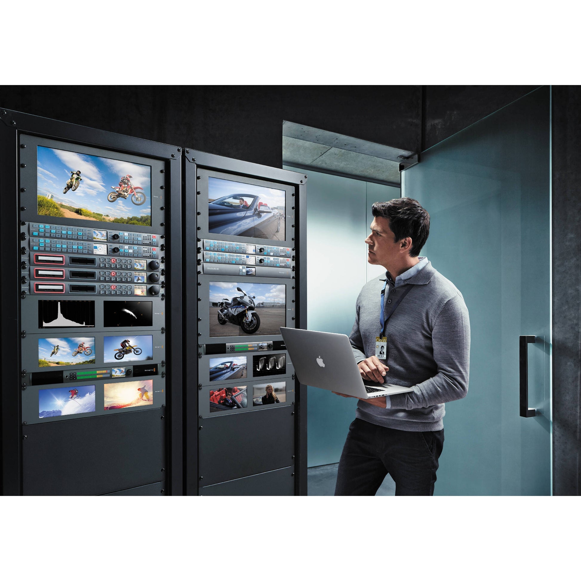 Blackmagic Design Teranex Express converter rack mounted in a machine room with monitors and an engineer on a laptop