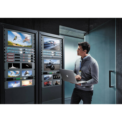 Blackmagic Design Teranex Express converter rack mounted in a machine room with monitors and an engineer on a laptop