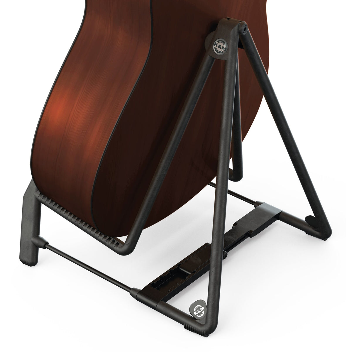 17580 Heli 2 guitar stand in use supporting an acoustic guitar body on the rubber-coated frame with adjustable crossbar and K&M logo badges, K&M