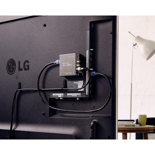 Blackmagic Design Mini Converter mounted behind an LG flat panel display with SDI and HDMI cables run