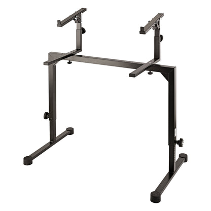 18811 Stacker second tier add-on, shown mounted on a black keyboard stand frame with both upper arms raised above the crossbar, K&M