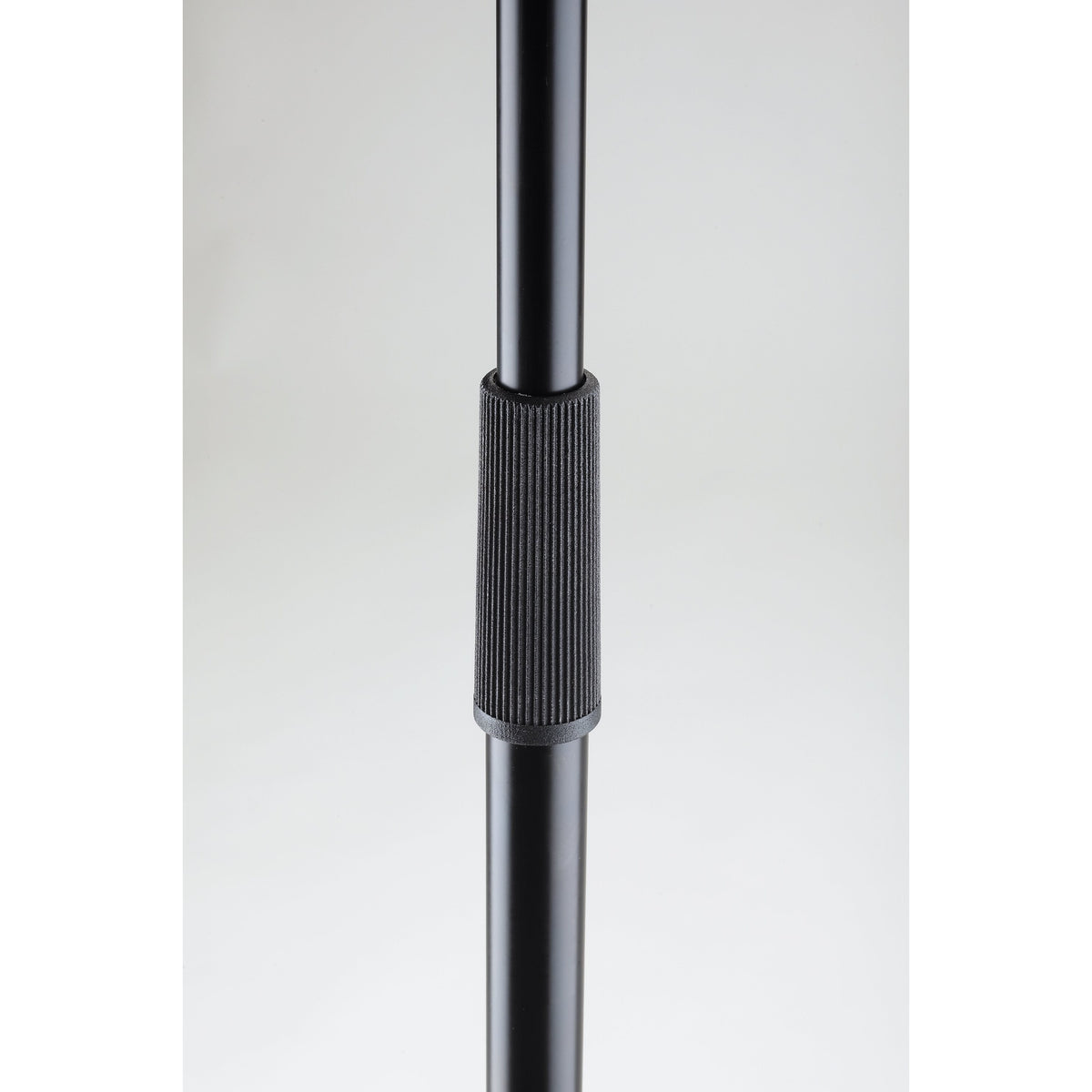 26125 mic stand height adjustment detail showing ribbed black clutch collar on telescoping shaft, K&M