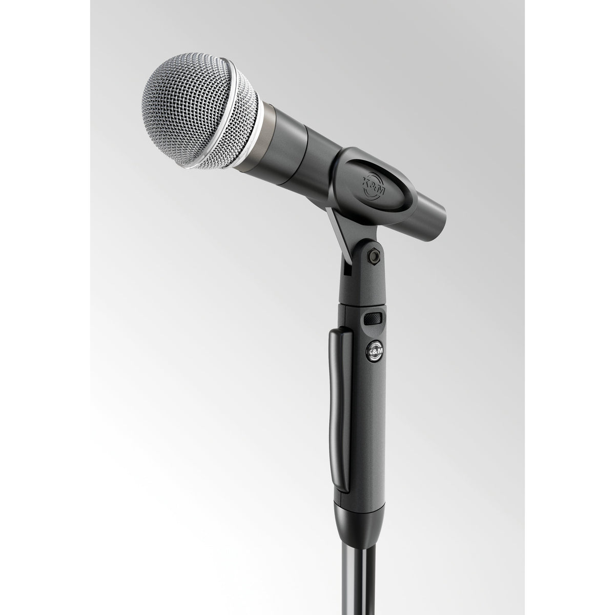 26200 Elegance One-Hand mic stand head detail with dynamic microphone held in clip, K&M logo and release grip visible, K&M