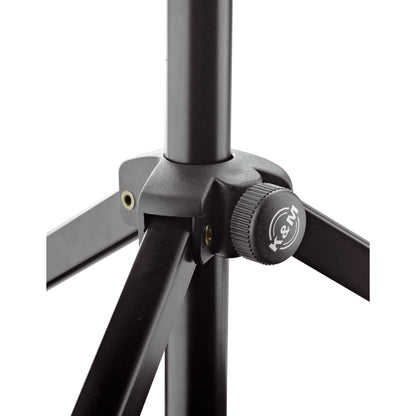 10065 music stand tripod base hub close-up showing K&M logo locking knob and leg attachment points, K&M
