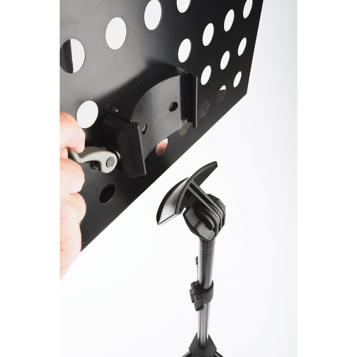 11940 orchestra music stand quick-release lock detail with hand operating grey lever to detach perforated desk from stand head, K&M